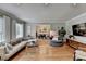 Bright living room with hardwood floors and comfortable seating, next to the dining room for open living at 1744 Chateau Dr, Dunwoody, GA 30338