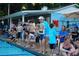 Community pool with swim team members and coaches with a view of the pool house at 1744 Chateau Dr, Dunwoody, GA 30338