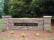 Elegant stone entrance sign for Chateau Woods, adding a touch of sophistication to the neighborhood's ambiance at 1744 Chateau Dr, Dunwoody, GA 30338