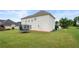Exterior view of the home showing the large, grassy backyard with a trampoline at 2127 Grant Ave, Mcdonough, GA 30252