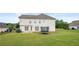 A view of the backyard with a trampoline, patio, and flower bush at 2127 Grant Ave, Mcdonough, GA 30252