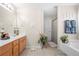 Well-lit bathroom with a tub, shower, vanity with storage, and decorative accents at 2127 Grant Ave, Mcdonough, GA 30252