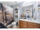 Bathroom featuring a tub-shower combo and wood vanity with marble countertop at 2127 Grant Ave, Mcdonough, GA 30252