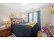 Bedroom with a large bed, side table, and curtains to filter the light at 2127 Grant Ave, Mcdonough, GA 30252