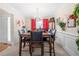 Elegant dining room with wooden table set for six, complemented by a chandelier and décor at 2127 Grant Ave, Mcdonough, GA 30252