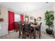 Elegant dining room with wooden table set for six, complemented by a chandelier and décor at 2127 Grant Ave, Mcdonough, GA 30252