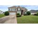 Beautiful home featuring a manicured lawn, a two-car garage, and an inviting entryway at 2127 Grant Ave, Mcdonough, GA 30252