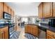 Well-lit kitchen features wood cabinets, stainless steel appliances, and granite countertops at 2127 Grant Ave, Mcdonough, GA 30252