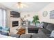 Inviting living room with a cozy fireplace and plush gray sectional sofa at 2127 Grant Ave, Mcdonough, GA 30252
