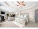 Spacious main bedroom with a tray ceiling, ceiling fan, fireplace, and comfortable sitting area at 2127 Grant Ave, Mcdonough, GA 30252