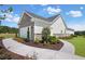 Side view of a charming home with gray brick, white siding and a concrete walkway at 248 Nesta Grove, Locust Grove, GA 30248