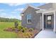 Inviting front entrance with gray brick, shuttered windows, and professional landscaping at 248 Nesta Grove, Locust Grove, GA 30248