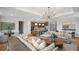 Open-concept living room with hardwood floors and an abundance of natural light at 248 Nesta Grove, Locust Grove, GA 30248
