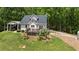 Charming home with a black metal roof, a wooden deck, and a lush green lawn at 291 Miquel Jorge Ln, Canton, GA 30115