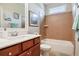 Well-lit bathroom with a tub-shower combo, tiled walls, and a vanity with storage at 355 Glynnwilde Nw Dr, Marietta, GA 30064