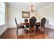 Elegant dining room with classic wainscoting, chandelier and hardwood floors at 355 Glynnwilde Nw Dr, Marietta, GA 30064