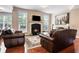 Inviting living room with hardwood floors, a cozy fireplace, and comfortable leather seating at 355 Glynnwilde Nw Dr, Marietta, GA 30064