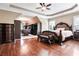 Spacious bedroom with hardwood floors, tray ceiling, and a walk-in closet at 355 Glynnwilde Nw Dr, Marietta, GA 30064