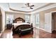 Large bedroom with hardwood floors, tray ceiling, and ensuite bathroom at 355 Glynnwilde Nw Dr, Marietta, GA 30064