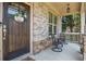 Inviting front porch with seating, decorative accents and charming curb appeal at 355 Glynnwilde Nw Dr, Marietta, GA 30064