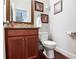 Cozy powder room featuring granite countertop and wood vanity at 355 Glynnwilde Nw Dr, Marietta, GA 30064