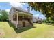Expansive backyard featuring a well-manicured lawn, mature trees, and a covered deck at 3717 Shady Maple Dr, Stonecrest, GA 30038