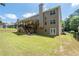 Spacious backyard with covered deck, patio, and lush green lawn at 3717 Shady Maple Dr, Stonecrest, GA 30038