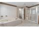 Bright bathroom featuring a soaking tub, a walk-in shower with glass doors, and a neutral color scheme at 3717 Shady Maple Dr, Stonecrest, GA 30038