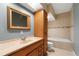 Neutral-toned bathroom showcasing a soaking tub, toilet, and vanity with sink, mirror, and cabinets at 3717 Shady Maple Dr, Stonecrest, GA 30038