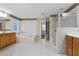 Bright bathroom with tile flooring, a walk-in shower, a soaking tub and a double sink vanity at 3717 Shady Maple Dr, Stonecrest, GA 30038