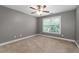 Empty bedroom with carpet, window and neutral walls at 3717 Shady Maple Dr, Stonecrest, GA 30038