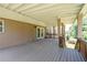 Covered deck with wooden railing and support beams, perfect for outdoor relaxation at 3717 Shady Maple Dr, Stonecrest, GA 30038