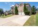 View of brick home showing driveway, two-car garage and trimmed trees next to the garage at 3717 Shady Maple Dr, Stonecrest, GA 30038