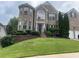 Charming brick home features a well-manicured lawn and an inviting entrance with manicured shrubs at 3717 Shady Maple Dr, Stonecrest, GA 30038
