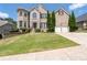 Charming two-story brick home with manicured lawn and attached two-car garage at 3717 Shady Maple Dr, Stonecrest, GA 30038