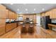 Modern kitchen with stainless steel appliances, granite countertops, a center island and hardwood floors at 3717 Shady Maple Dr, Stonecrest, GA 30038
