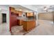 Bright kitchen featuring light brown cabinets, a kitchen island with bar seating and decorative tile floors at 3717 Shady Maple Dr, Stonecrest, GA 30038