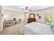 Carpeted bedroom featuring a desk, dresser, ceiling fan, and two windows at 622 Rocky Creek Pt, Woodstock, GA 30188