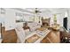 Cozy living room with stone fireplace, hardwood floors, and open access to the kitchen at 622 Rocky Creek Pt, Woodstock, GA 30188