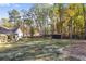 Spacious backyard featuring a shed and a partially fenced-in yard and home with a covered porch at 728 Harmony Rd, Temple, GA 30179