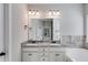 Bathroom featuring double sinks, granite countertops, white cabinets, and a large mirror at 728 Harmony Rd, Temple, GA 30179
