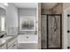 Well-lit bathroom featuring granite countertops, tile floor, soaking tub and glass shower at 728 Harmony Rd, Temple, GA 30179