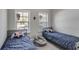 Shared bedroom with twin beds featuring playful star-themed decor, and two windows for natural light at 728 Harmony Rd, Temple, GA 30179