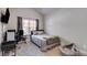 Bedroom with window, carpeted floor, small workstation, and tv mounted on the wall at 728 Harmony Rd, Temple, GA 30179