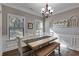 Dining area with wainscoting, modern lighting, and views of the backyard at 728 Harmony Rd, Temple, GA 30179