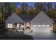 Twilight view of a charming home with white siding, stone accents, and a welcoming front porch at 728 Harmony Rd, Temple, GA 30179