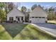 Charming home with white siding, stone accents, and a welcoming front porch with chairs and a driveway at 728 Harmony Rd, Temple, GA 30179