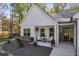 Inviting front porch with neutral chairs, hanging plants, and a charming front door at 728 Harmony Rd, Temple, GA 30179
