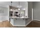 Bright kitchen featuring a granite countertop island and modern pendant lighting at 728 Harmony Rd, Temple, GA 30179