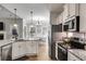 Well-lit kitchen with stainless steel appliances and granite countertops at 728 Harmony Rd, Temple, GA 30179